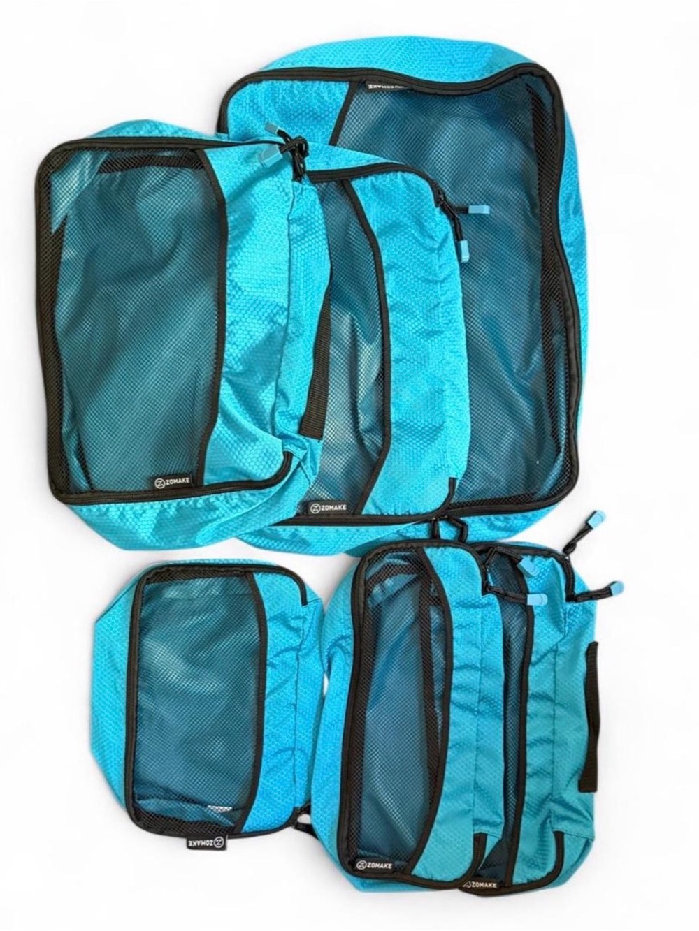 Zomake blue packing cubes with black mesh. Set of 6, like new.